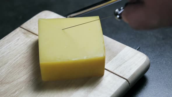 Maasdam Cheese Is Cut on a Special Board for Cutting