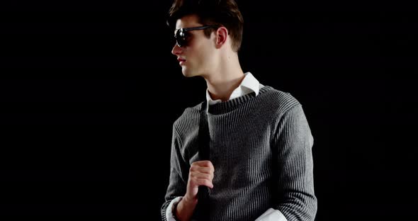 Androgynous man posing against black background alt