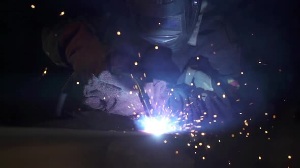 Person is welding metal object in construction site.
