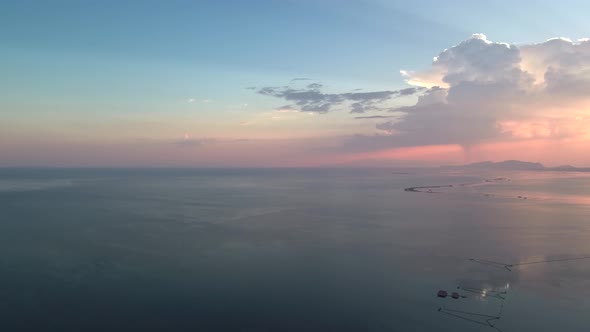 Sunset in Mesologgi Greece. Aerial view of the sunset behind clouds and sea horizon. alt