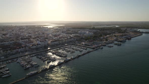 Aerial View of the Coastal village of Vila Real Santo Antonio and marina, Bright sunlight alt
