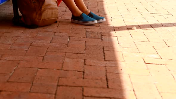 Sad schoolgirl sitting in locker room 4k alt