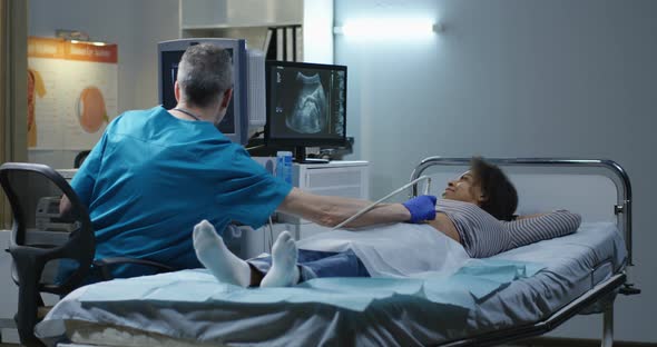 Doctor Examining Woman with Ultrasound alt