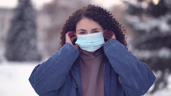 Pretty Woman in a City Wearing Face Mask Protective for Spreading of Disease Virus SARSCoV2 alt