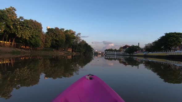 Kayaking through an Asian City at Sunset alt
