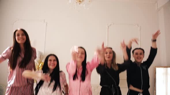 Five Cheerful Ladies in Pajamas Jumps Up and Have a Lot of Fun Together