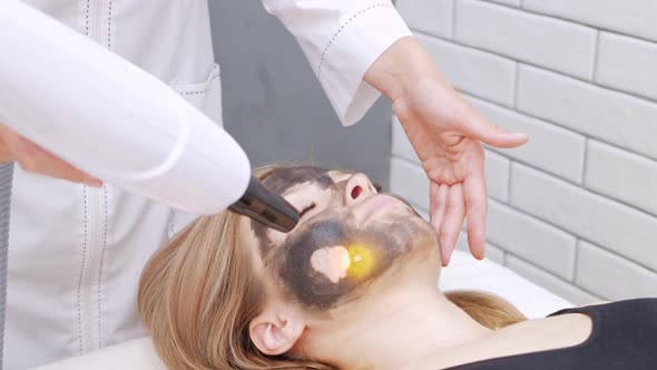 Cosmetologist Does Procedure of Carbon Peeling of Face