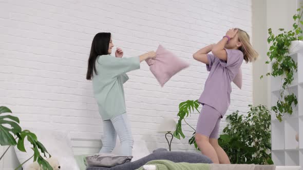 Young Girls Dancing on the Bed at Home alt