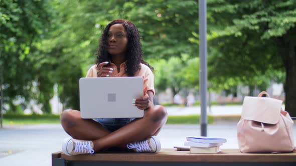 African Student Girl with Laptop and Books in City alt