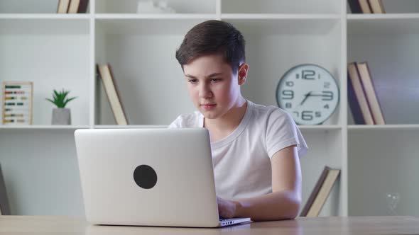 Scared Boy Shocked By Terrible Scene While Reading Horror News on Computer alt