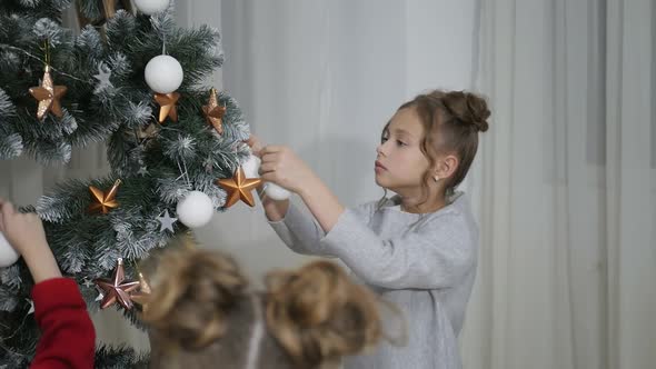 Happy American family celebrating Christmas. Children open a gift at home. alt