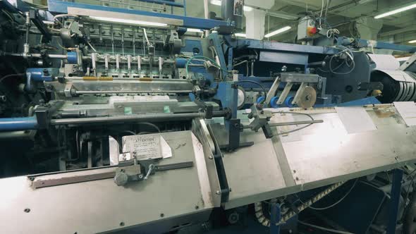 Industrial Mechanism with Paper Pages Getting Processed in It alt