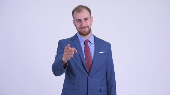 Happy Bearded Businessman Pointing at Camera