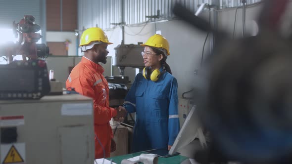 engineer cooperation male and female technician maintenance control relay robot arm alt