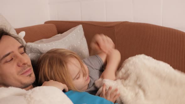 Dad Puts His Daughter to Bed Lies on Bed Pats Her Head Hugs