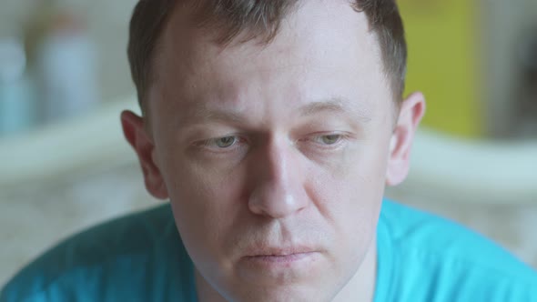 Portrait of a Sad Young Man with Gray Eyes Looking at the Camera Selective Focus alt