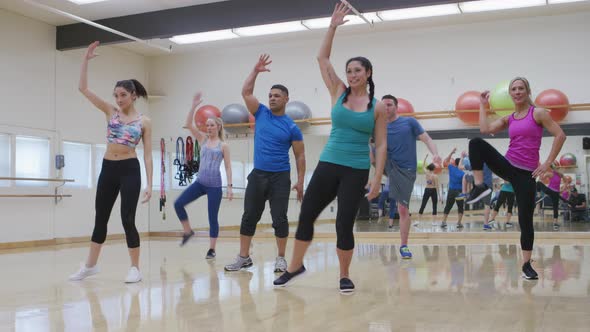 Group of people doing exercise class at gym