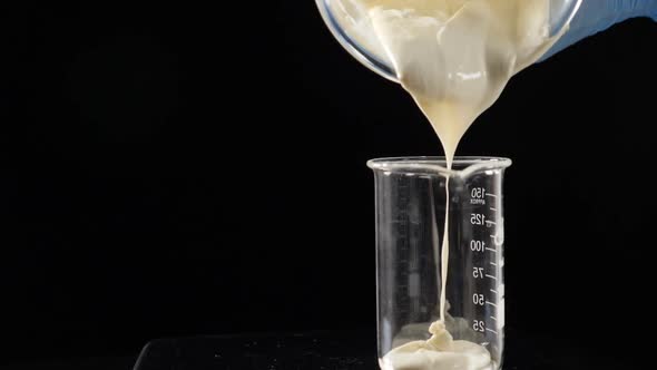Making Body Care and Aroma Production Lab Worker Pouring Chemical Liquid in Glass Tube Perfumery alt