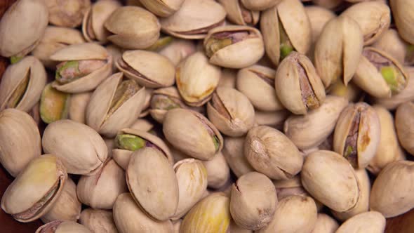 Close-up of Macro Roasted Peanuts Falling Into a Bowl
