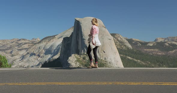 Young Attractive Girl Walking Outdoors on Background of Mountain Landscape, USA alt