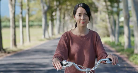 Woman ride a bike in countryside alt