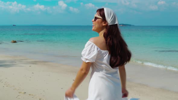 cheerful woman walking on the sea beach at Koh MunNork Island, Rayong, Thailand alt