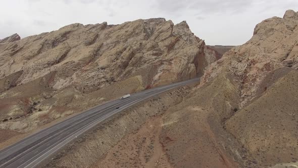Rising aerial view of I-70 at the edge of the San Rafael Swell alt