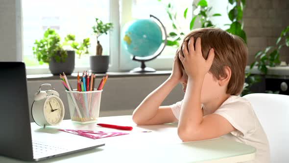 Little Boy Elementary School Student Falls Asleep at the Table Fatigue and Overwork of Firstgrader alt