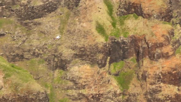 Tracking Shot of Helicopter Tourists Flying in Red Green Volcano Canyon Kauai alt