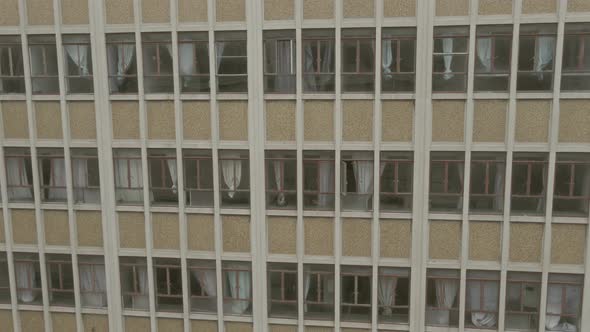 Drone Descending Past Grunge Looking Windows alt