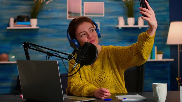 Social Media Influencer Using Phone for Taking Selfie Recording Podcast alt