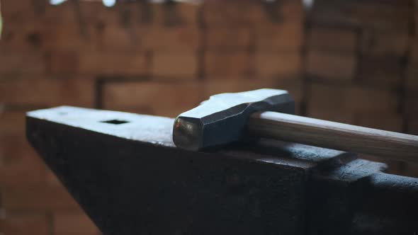 Forge Workshop Side View of Hammer for Beating Hot Metal for Formation of Products Lies on Anvil in alt