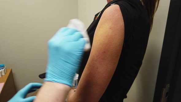 Nurse Administers A Coronavirus COVID-19 Vaccine Shot To An Adult Female Patient alt