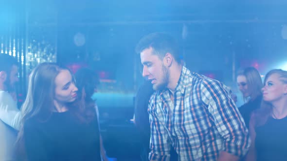 Handsome Guy is Dancing at a Party in a Fashionable Nightclub alt
