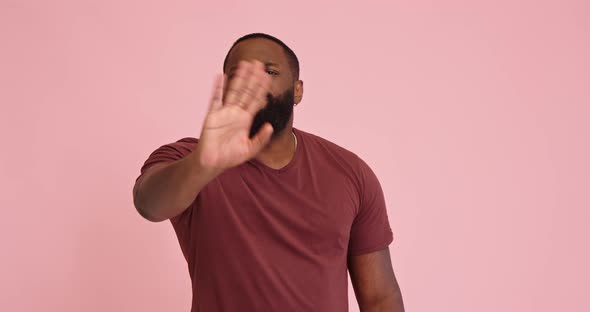 Young African American Man Disagree Show Thumb Down on Pink Background alt