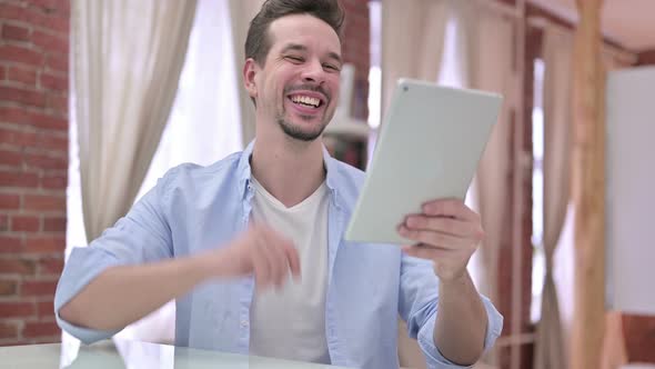 Young Man Doing Video Chat on Tablet alt