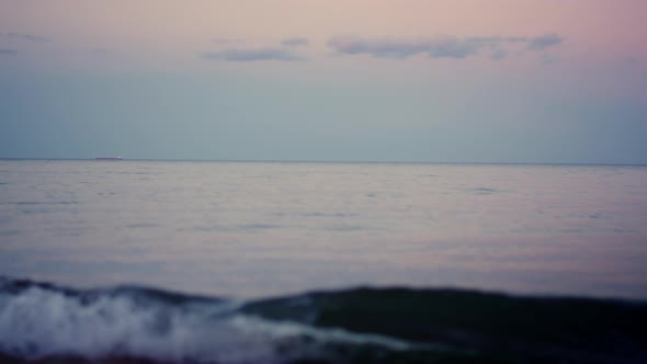 Calm Ocean Surface Horizon at Pink Sky in Cold Morning Dawn alt