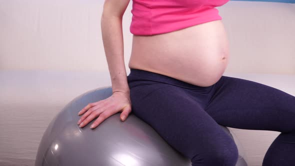 Pregnant Woman Exercising on Fit Ball.