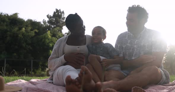 Happy multiracial family having playful time at park - Family love concept alt