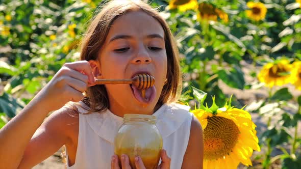 A Child Eats Honey From Flowers alt