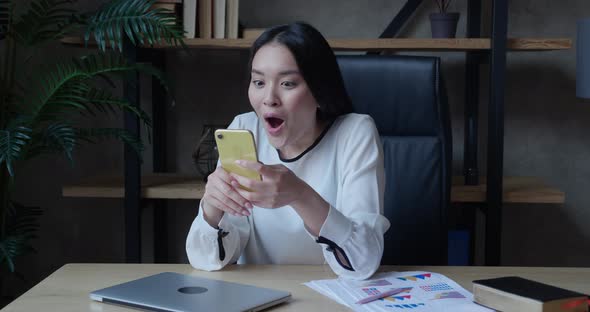 Excited Young Asian Lady User Winner Hold Smartphone Feel Amazed with Good Surprise Social Media alt