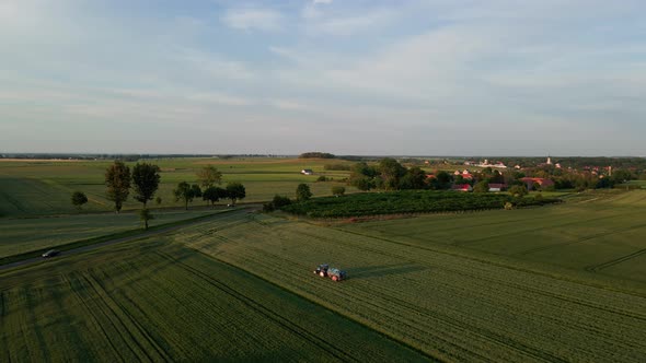 Tractor Spray Fertilizer on Agricultural Field Aerial View alt