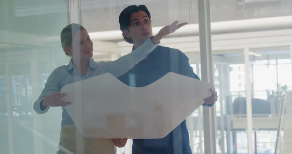 Young man and woman working in a creative office alt