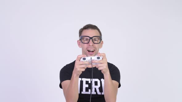 Studio Shot of Happy Nerd Man Playing Games alt