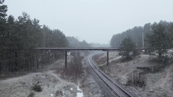 AERIAL: Overpass Bridge over the Railway on a Snowy Day alt