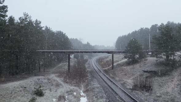 AERIAL: Overpass Bridge over the Railway on a Snowy Day