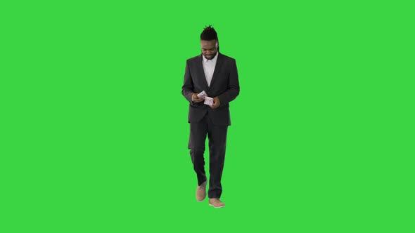 Black Man in Office Suit Walk Counting Money on a Green Screen Chroma Key alt