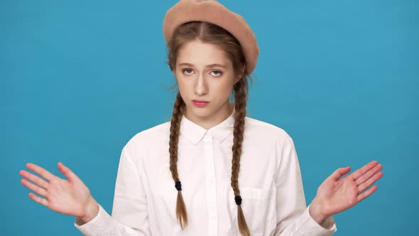 Portrait Closeup of Persistent Woman 20s Wearing French Beret Shaking Head and Waving Hands in alt
