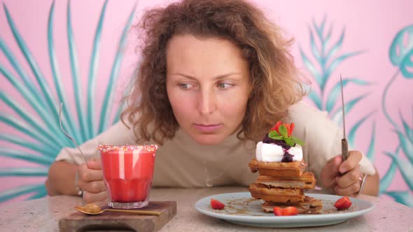 Portrait of a Hungry Caucasian Woman Looking at the Vegan Waffles and Plant Based Milkshake alt