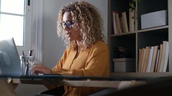 Blond businesswoman working on laptop in office